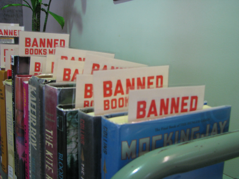 banned books on a green cart