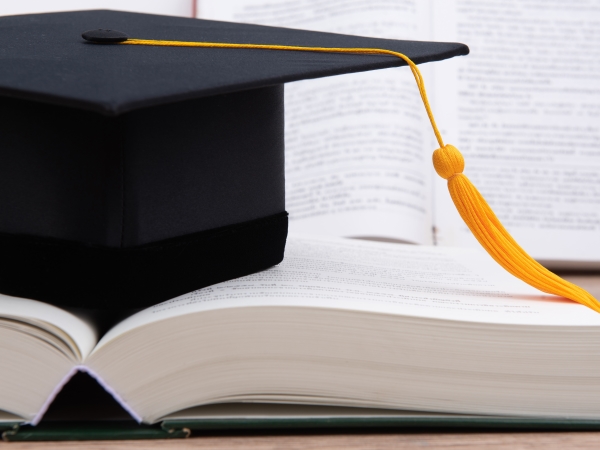 graduation cap on a book