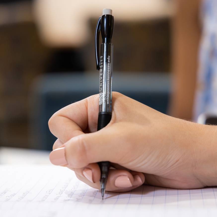 a hand writing with a pen
