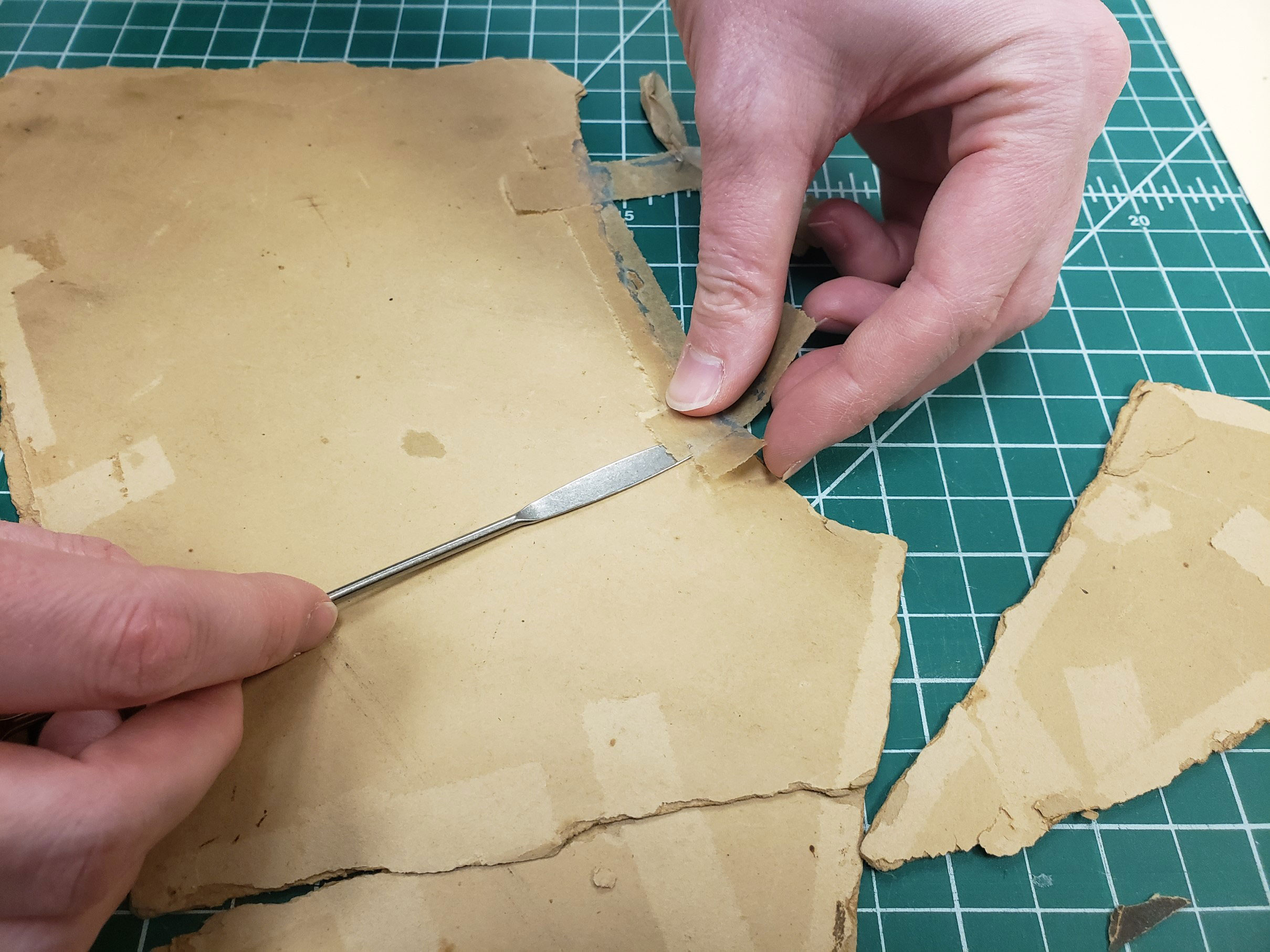 Removing tape with micro spatula
