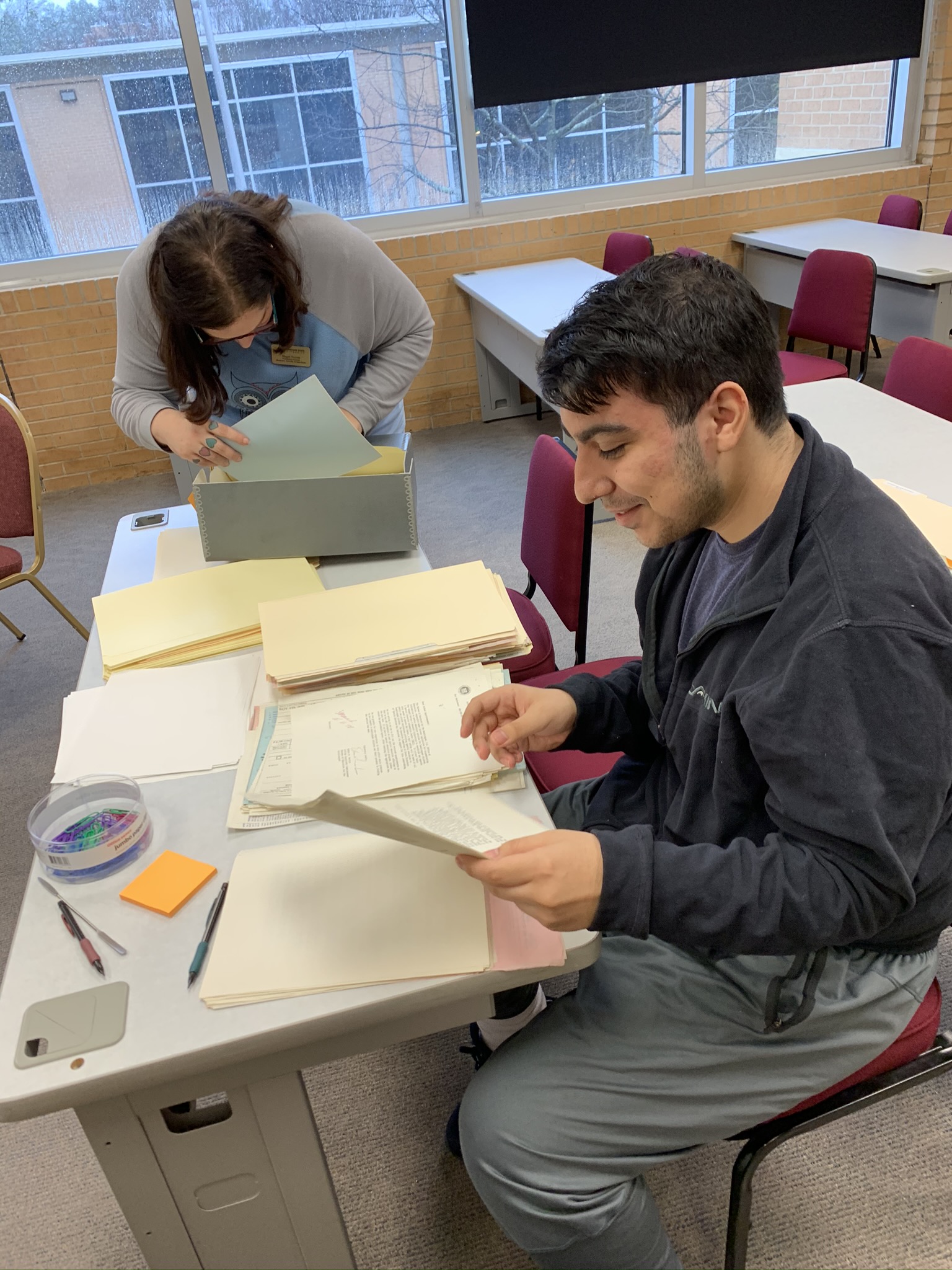Tony Festa assists Processing Archivist Maggie Thomas with processing the Marietta City Schools collection.