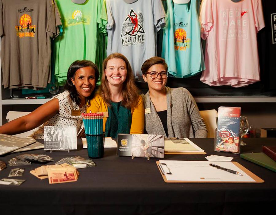 group of KSU faculty sitting a Museums, Archives and Rare Books booth.