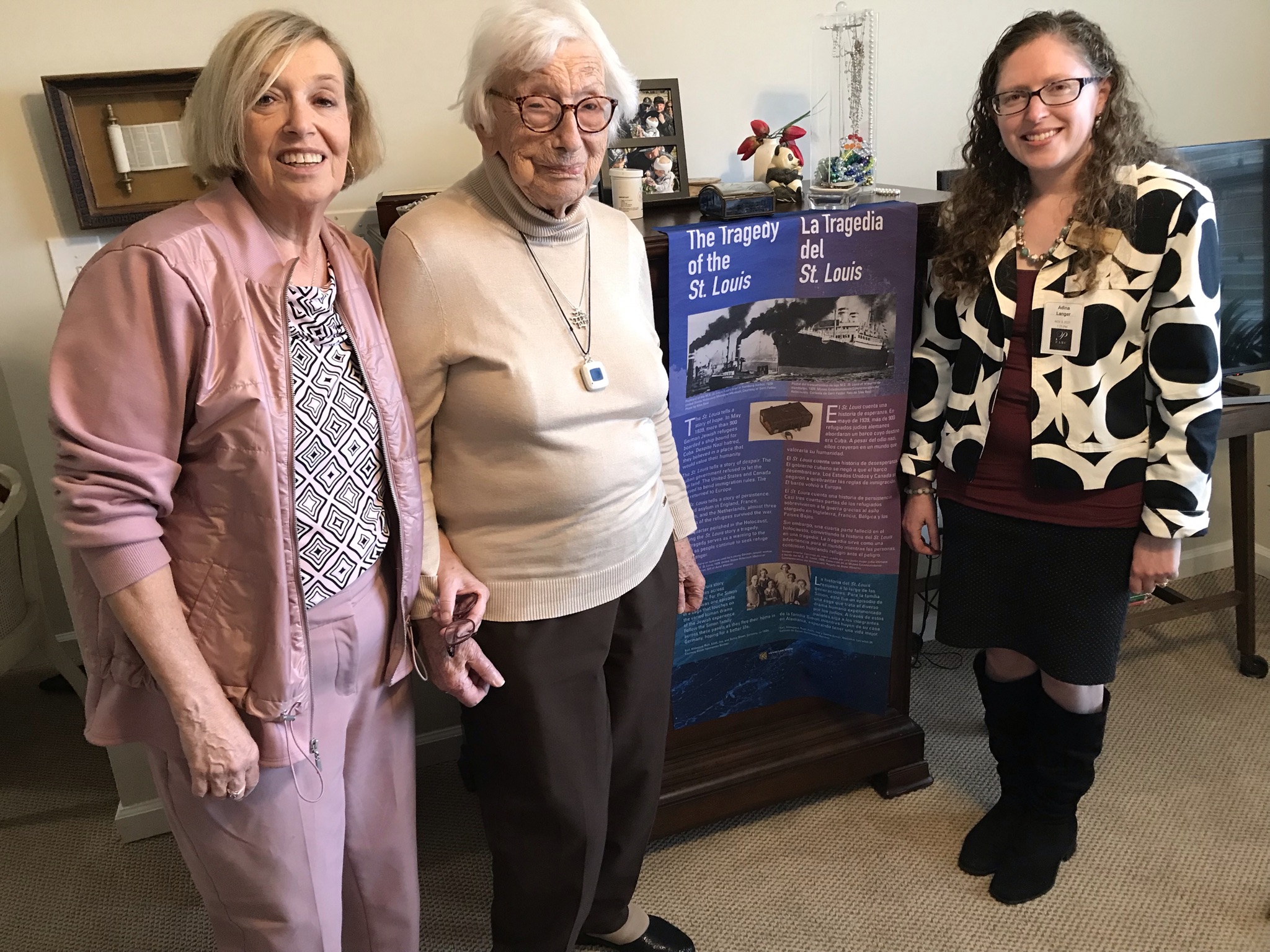 Susan Berman, Ruth Heinemann, and Adina Langer with the first banner of the Tragedy of the St. Louis Exhibit, November 2021