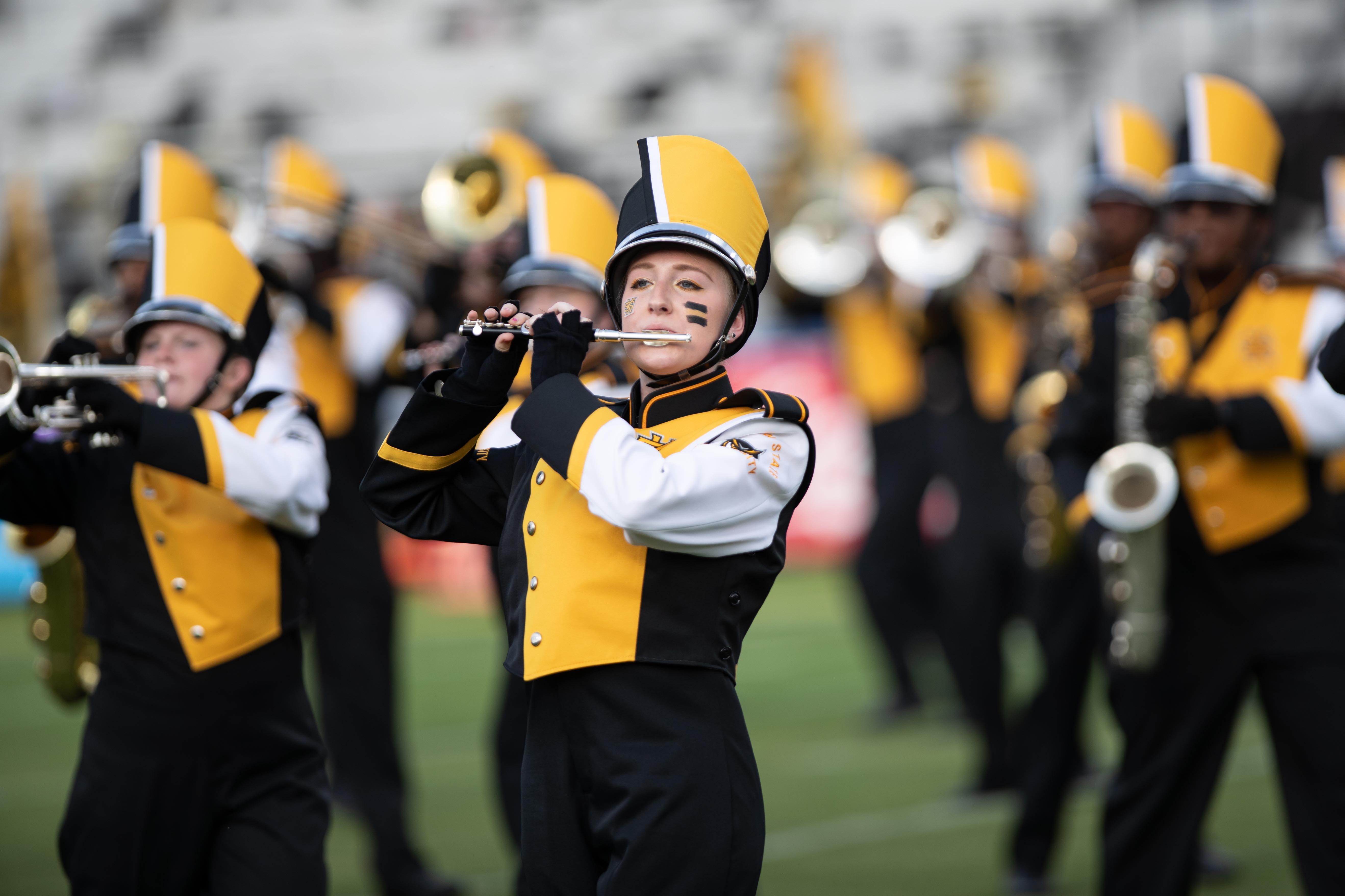 KSU's 2026 Marching Band / Pictures of KSU's marching band in uniform playing at a game with school spirit.