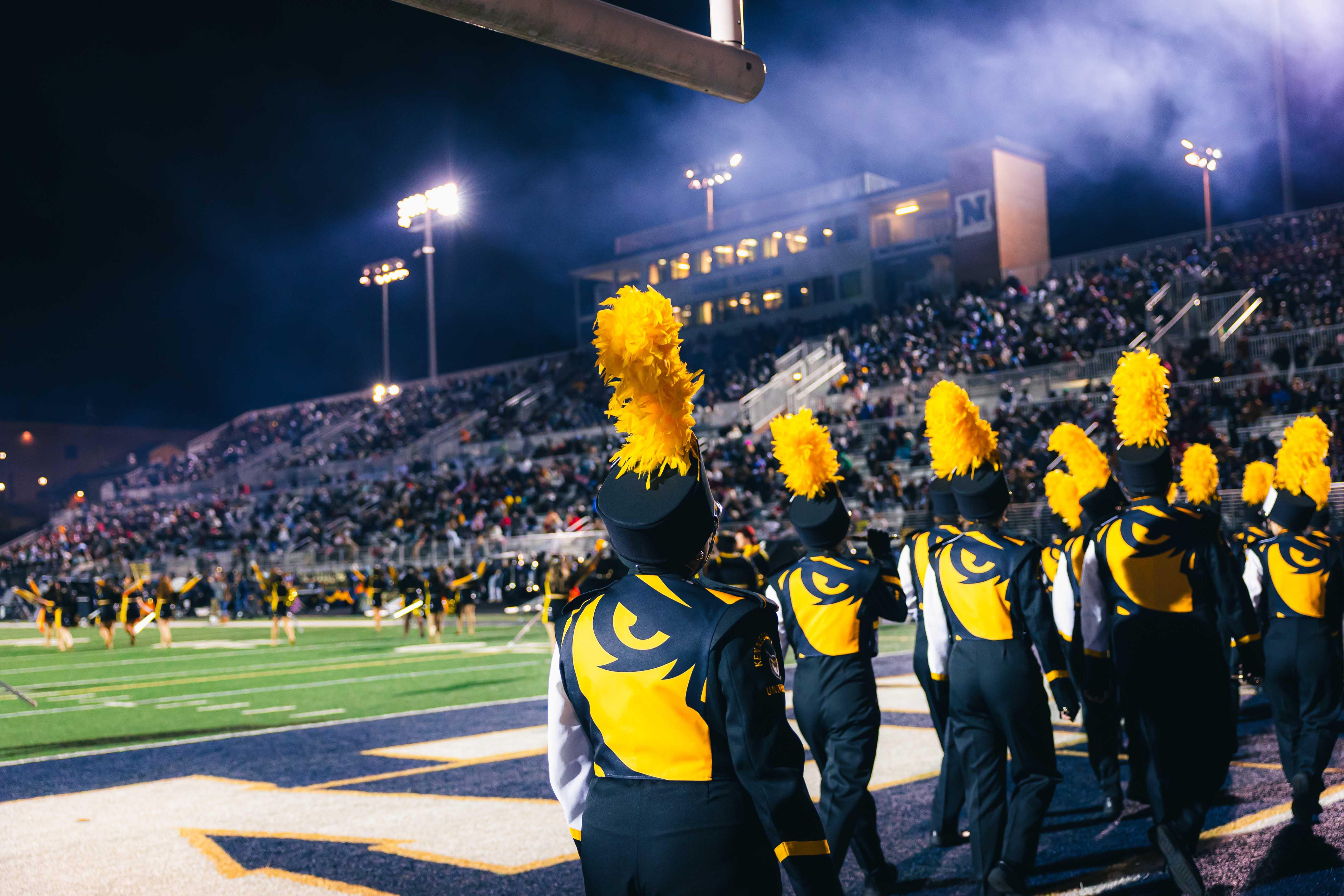 KSU's 2026 Marching Band / Pictures of KSU's marching band in uniform playing at a game with school spirit.