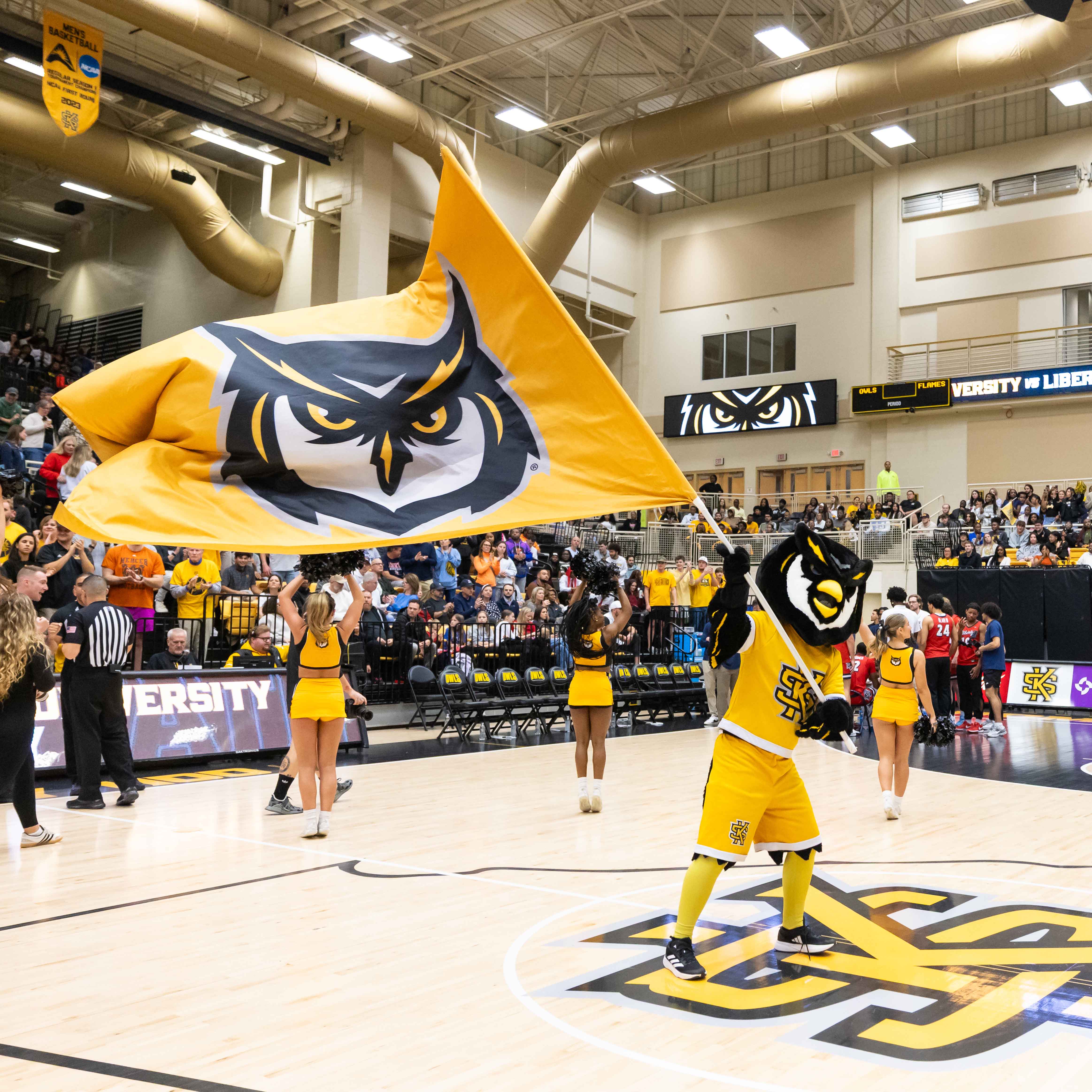 scrappy owl holding flag at ksu basketball game