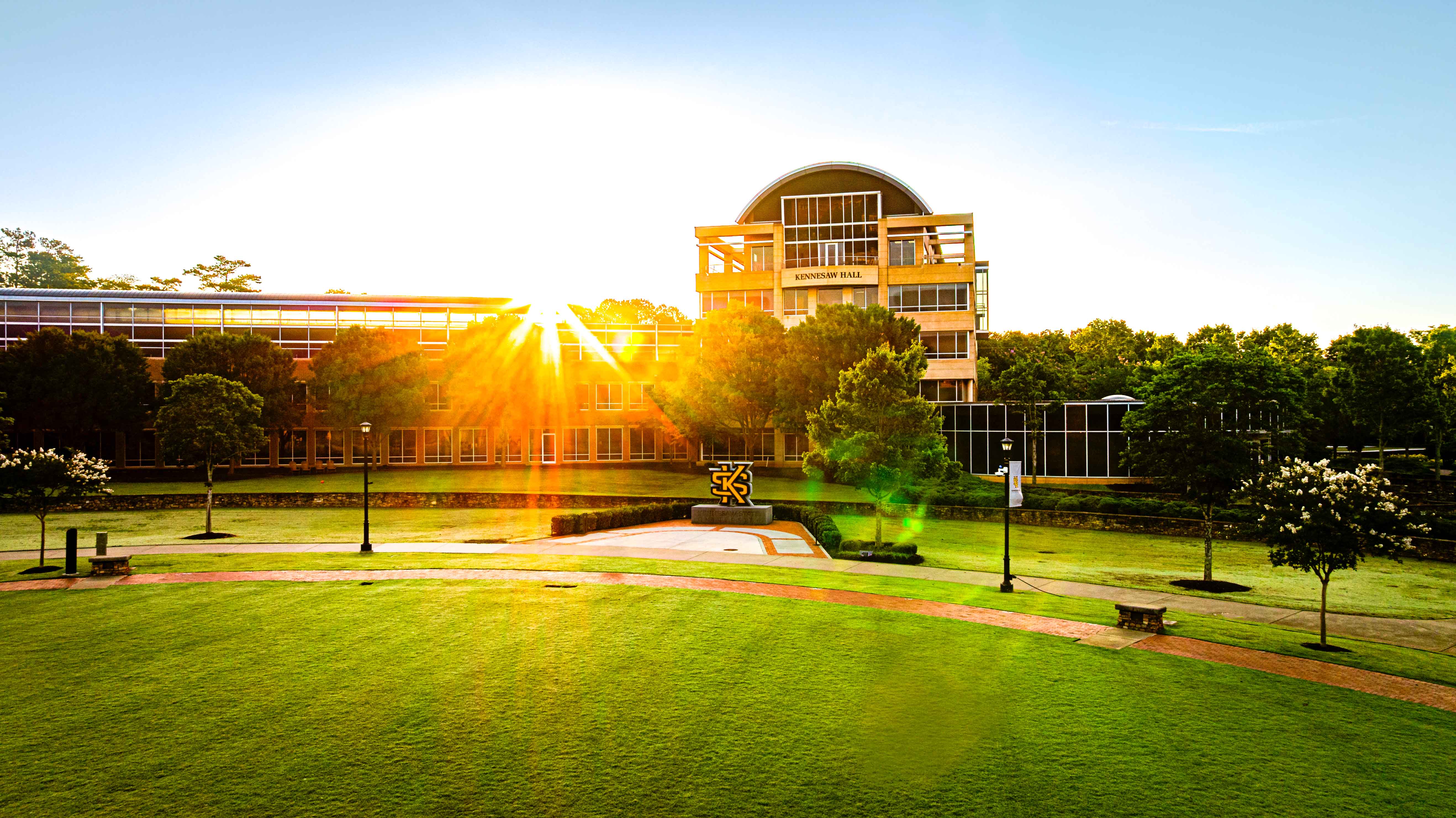 exterior of ksu's campus green with sun glare on a sunny day