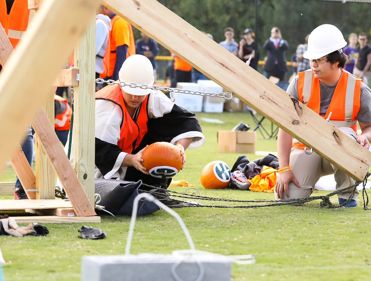 Two students load their trebuchet at Pumpkin Launch 2019