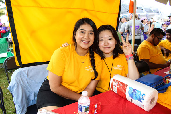 Two people sitting and smiling.