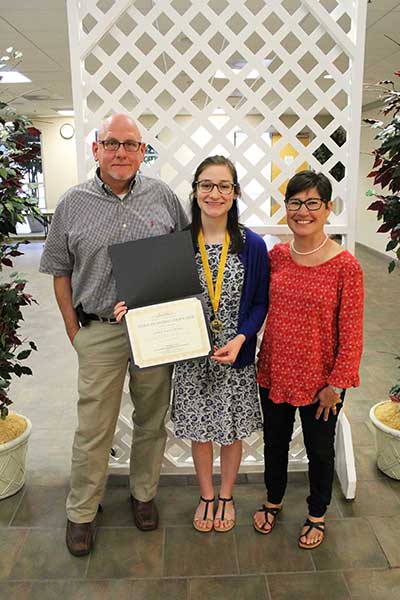 Patterson with her proud parents. Patterson shared her student testimony at Wednesday's ceremony.