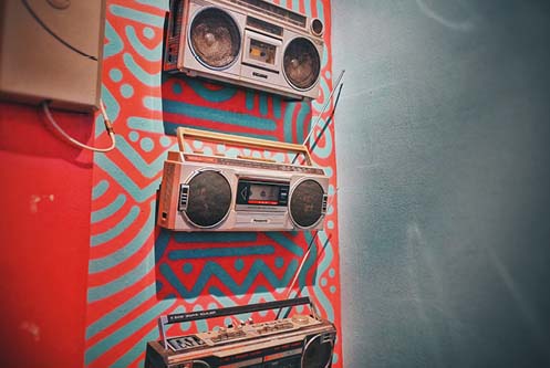 Boomboxes on a colorful wall