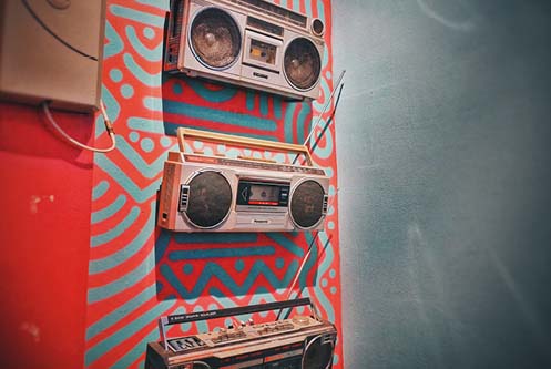 Boomboxes on a colorful wall