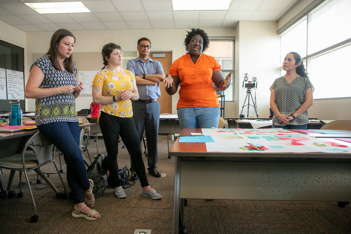 Graduate students present of a grantor about a project in the area of community mental health