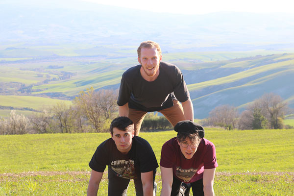 Photo of 3 men in a pyrimad pose in Tuscany
