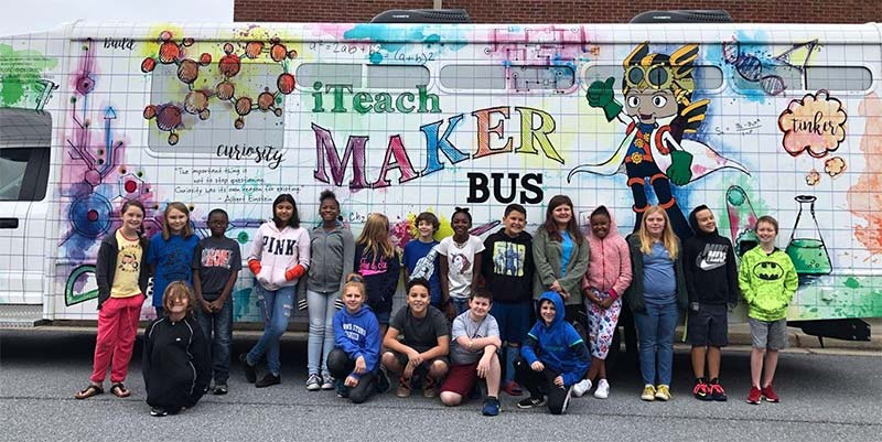 Photo of students standing in front of iTeach Makerbus