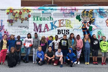 Photo of students in front of iTeach MakerBus