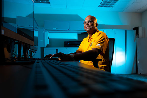 Photo of man sitting at computer