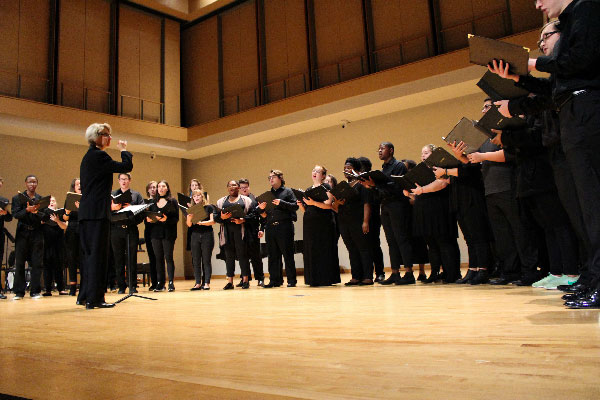 KSU Chamber Singers singing in a concert hall.
