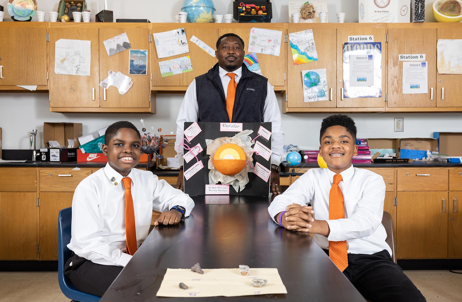 Photo of students Matthew Mbongwo and Noah Khalid with teacher Alexander Shannon in classroom setting