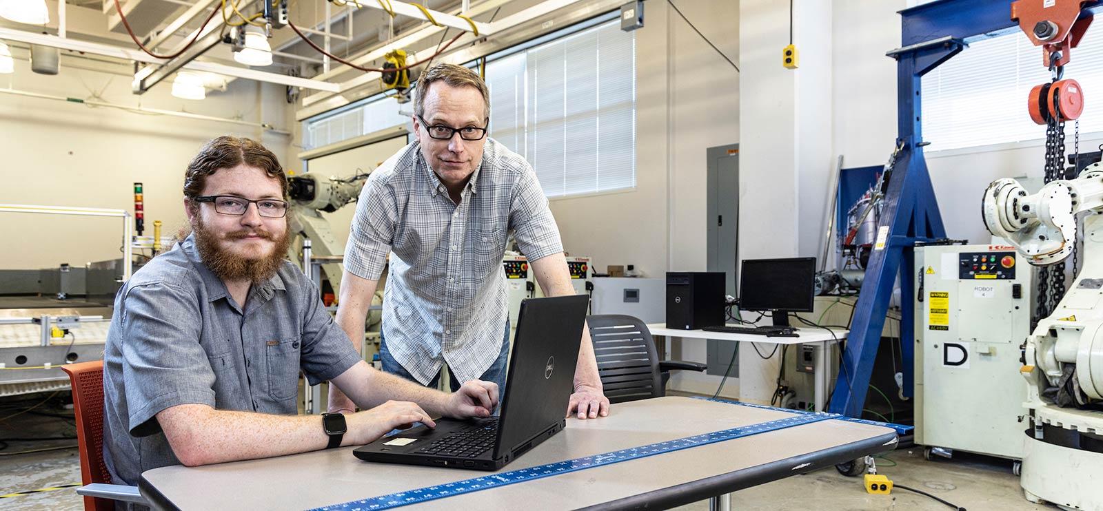 Photo of Nolan Gilmore and Joe Gilmore in engineering space