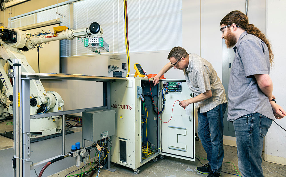 Photo of Nolan and Joe Gilmore in engineering lab