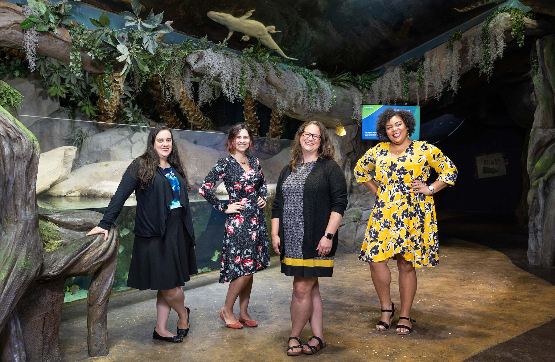 Photo of Anna Arias, Molly Johnson, Jessica Stephenson Reaves, Rasheda Likely with aquarium in background