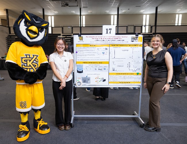 students pose with ksu mascot scrappy at the fall symposium of student scholars