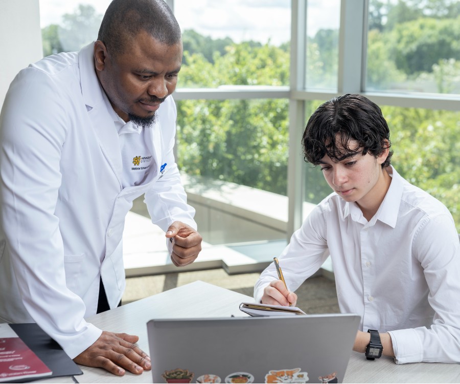 Nursing professor Chinomso Nwozichi, left, and student researcher Isaac Kuhn.