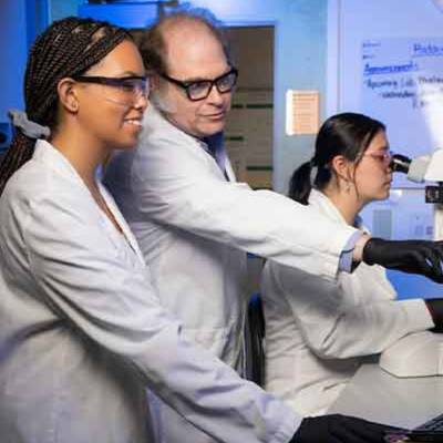 andrew haddow and students focusing on research.