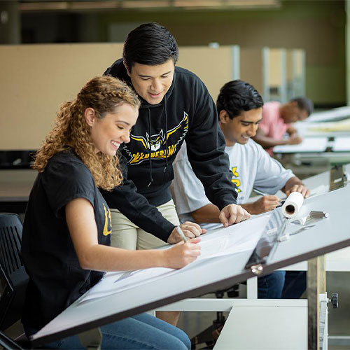 group of ksu architecture students working on a project.