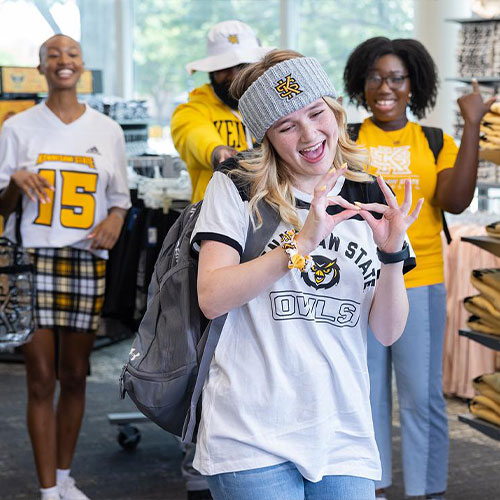 group of students wearing ksu gear smiling and having fun.