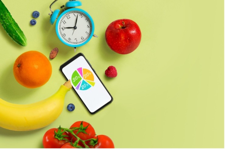 A pie chart, surrounded by a fruits and a blue clock on a light green backdrop.
