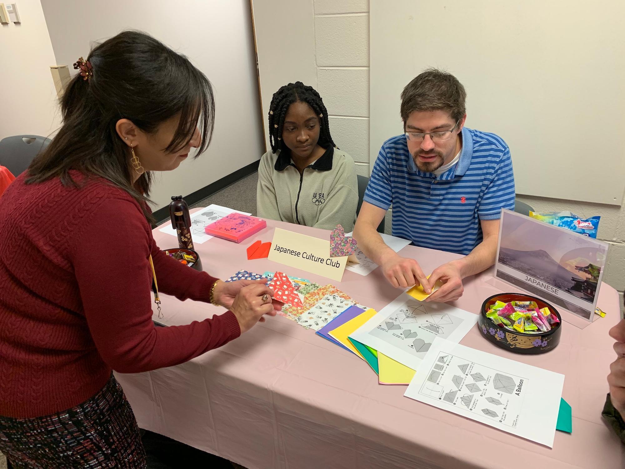Sylvia Ayoub (Arabic Instructor) practices origami with the Japanese Culture Club  / Sylvia Ayoub (Arabic Instructor) practices origami with the Japanese Culture Club 