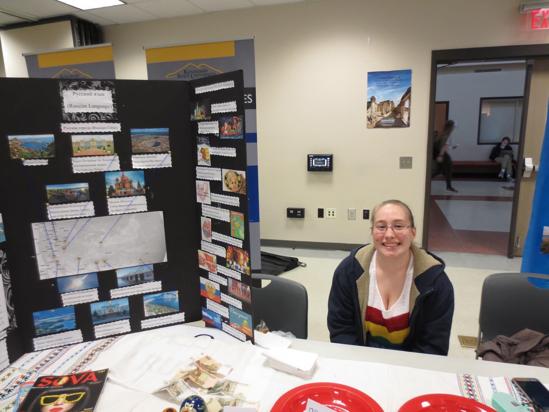  / student next to greek display