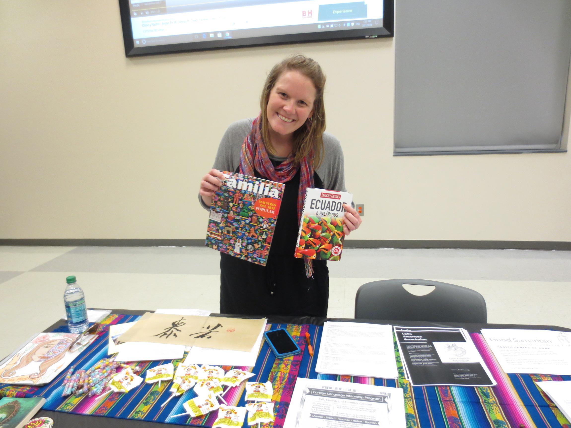  / student holding magazine and book that say familia and ecuador