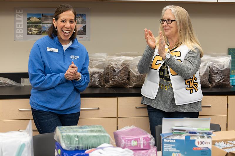  / two female faculty members at kennesaw state university smiling and clapping their hands