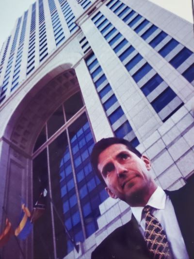 Norman J. Radow standing in front of a condo tower in Atlanta.