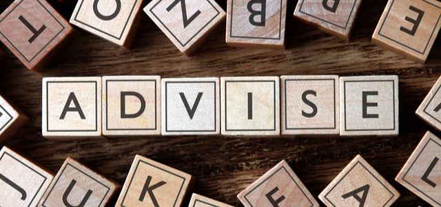 Wooden letter tiles spelling 'ADVISE' on a rustic surface.