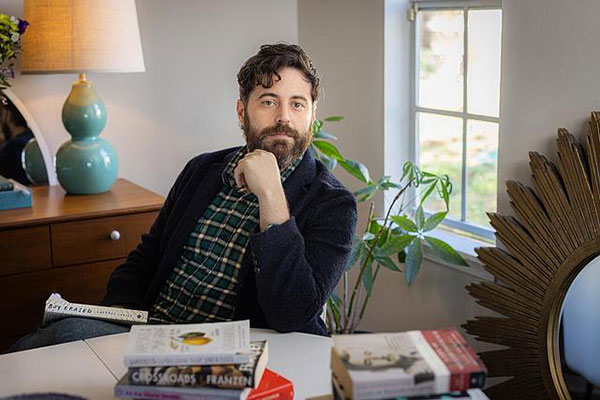 creative writer at desk with book