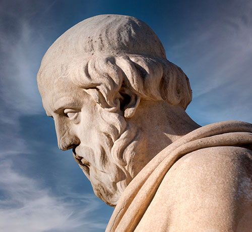 A bearded statue symbolizing a Greek philosopher renowned for his transformative ideas and contributions to society.