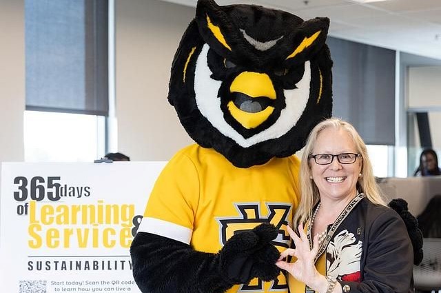 Woman with KSU's mascot, Scrappy the Owl