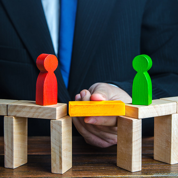 man with wooden blocks with 2 person blocks