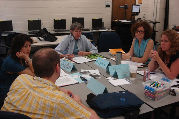 group of people at table learning professionally