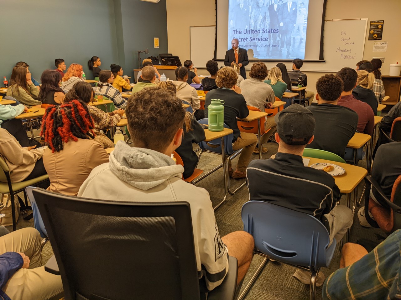 A KSU class of students engaged with a presentation on the secret service.