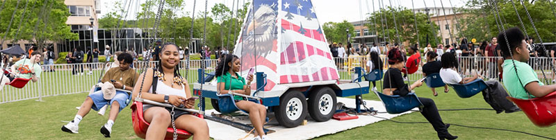 students on carnival ride on campus