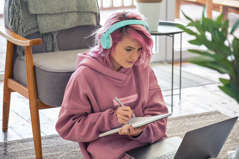 young pink haired college student studying