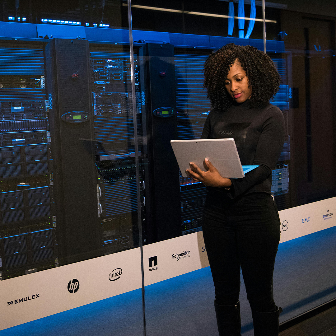 african american female on computer in front of cyber database center