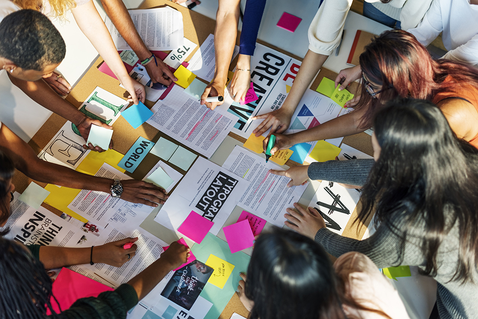 group of designers working on a typography layout design board