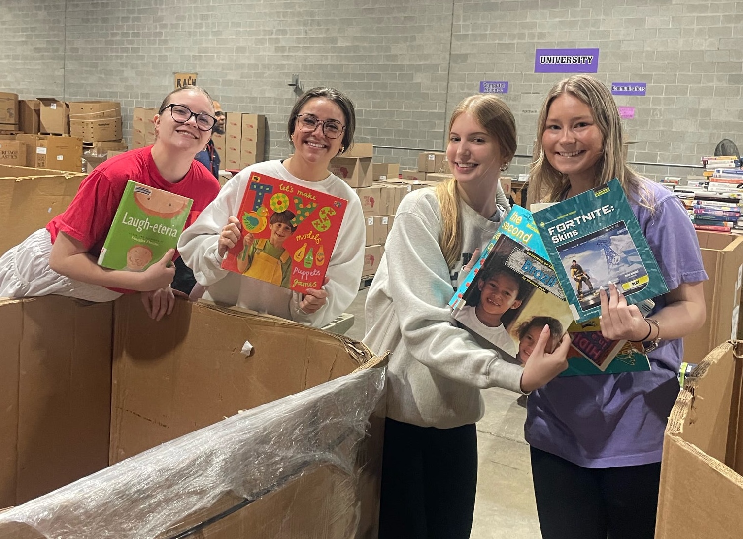 Students sorting books / 