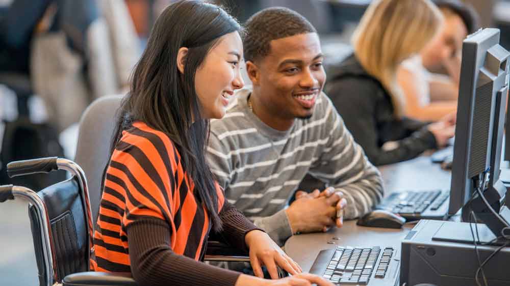 ksu students studying on laptop together